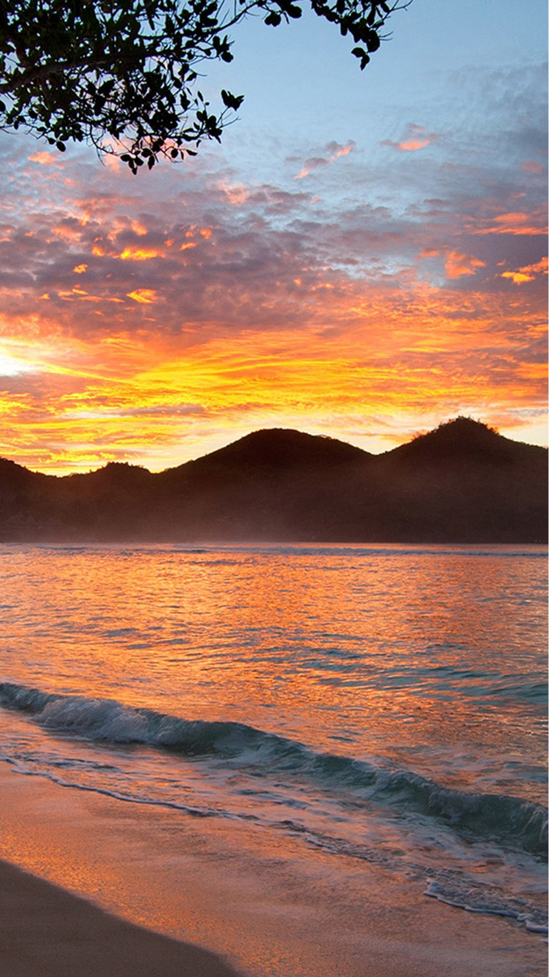 Sunset with mountains on beach